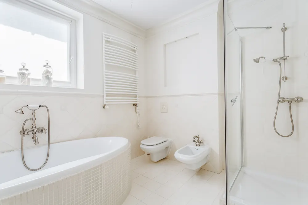 Bathroom with a soaking tub beside a frameless glass shower