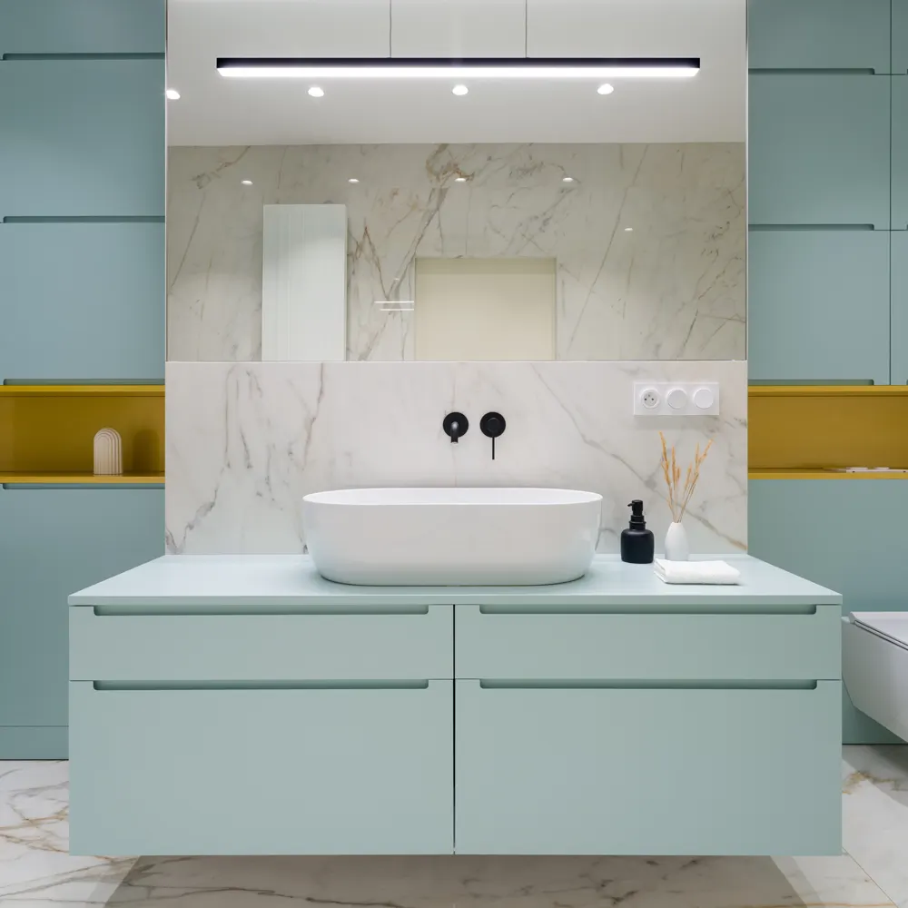 Modern bathroom with marble walls and a sealed glass vanity