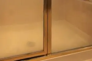 Untreated shower glass with water spots and soap scum