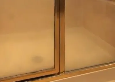 Cloudy, spotted untreated shower glass